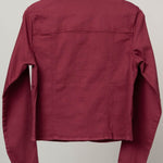 A maroon long-sleeve cropped shirt jacket with scalloped edges on the collar and cuffs, hanging on a wooden hanger against a plain light gray background.