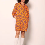 Woman wearing the Maude Vivante Ava Dress in the Tigers print, featuring an artistic tiger-inspired pattern, collared button-front design, three-quarter balloon sleeves, contrast trim, and a relaxed A-line silhouette.