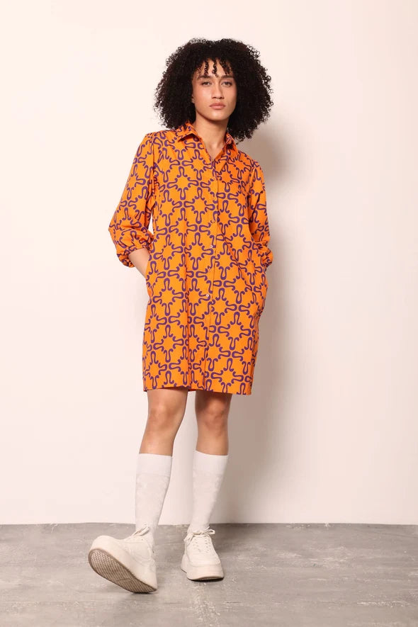 Woman wearing the Maude Vivante Ava Dress in the Tigers print, featuring an artistic tiger-inspired pattern, collared button-front design, three-quarter balloon sleeves, contrast trim, and a relaxed A-line silhouette.