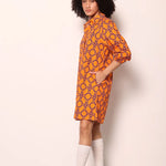 Woman wearing the Maude Vivante Ava Dress in the Tigers print, featuring an artistic tiger-inspired pattern, collared button-front design, three-quarter balloon sleeves, contrast trim, and a relaxed A-line silhouette.