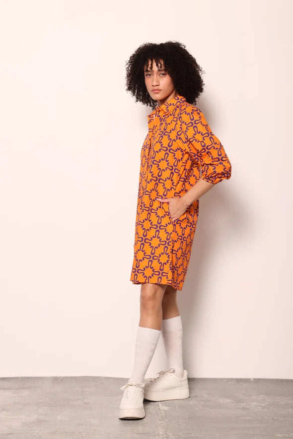 Woman wearing the Maude Vivante Ava Dress in the Tigers print, featuring an artistic tiger-inspired pattern, collared button-front design, three-quarter balloon sleeves, contrast trim, and a relaxed A-line silhouette.