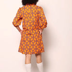 Woman wearing the Maude Vivante Ava Dress in the Tigers print, featuring an artistic tiger-inspired pattern, collared button-front design, three-quarter balloon sleeves, contrast trim, and a relaxed A-line silhouette.