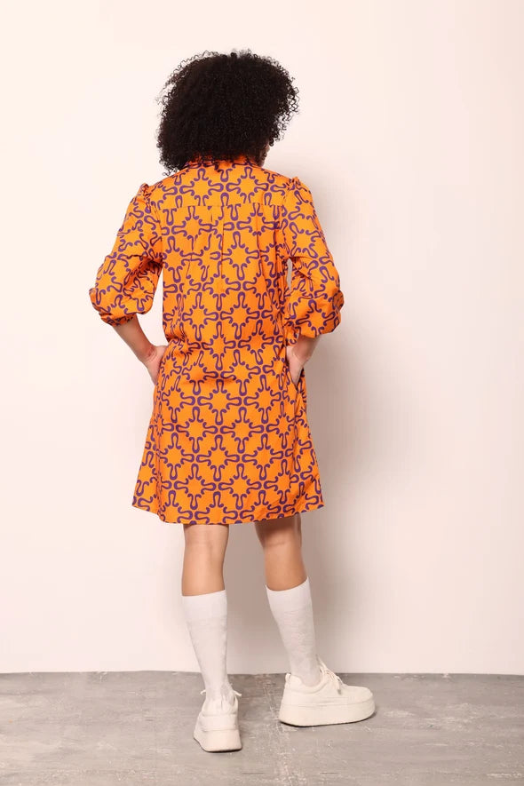 Woman wearing the Maude Vivante Ava Dress in the Tigers print, featuring an artistic tiger-inspired pattern, collared button-front design, three-quarter balloon sleeves, contrast trim, and a relaxed A-line silhouette.