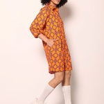 Woman wearing the Maude Vivante Ava Dress in the Tigers print, featuring an artistic tiger-inspired pattern, collared button-front design, three-quarter balloon sleeves, contrast trim, and a relaxed A-line silhouette.