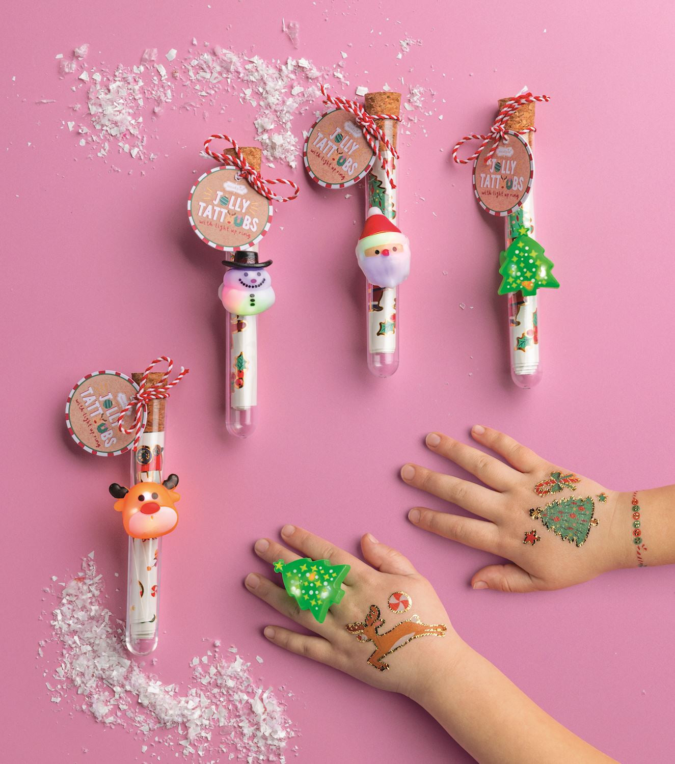 Mud Pie Jolly Tattoos and Light-Up Ring Set featuring gold foil Christmas temporary tattoos in a corked tube with a festive light-up character ring.