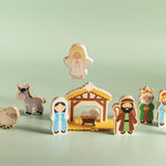 Mud Pie Nativity Wood Toy Set featuring wooden Nativity figures, animals, baby Jesus, manger, and hay for children's Christmas play.