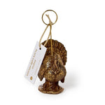 A small metallic turkey-shaped hanging ornament or card holder with a gold-tone ring at the top and a white paper tag attached, photographed on a clean white background.