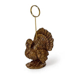 Alt Text:
Hand-painted resin turkey placecard and photo holder by Two's Company, featuring detailed sculptural accents for Thanksgiving tables and fall décor.