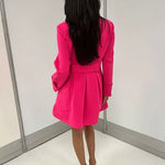 omen's hot pink honeycomb-textured statement coat with double-breasted covered buttons, high neckline, long sleeves, and front pockets.