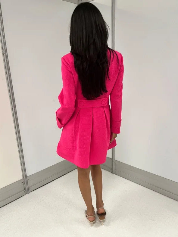 omen's hot pink honeycomb-textured statement coat with double-breasted covered buttons, high neckline, long sleeves, and front pockets.