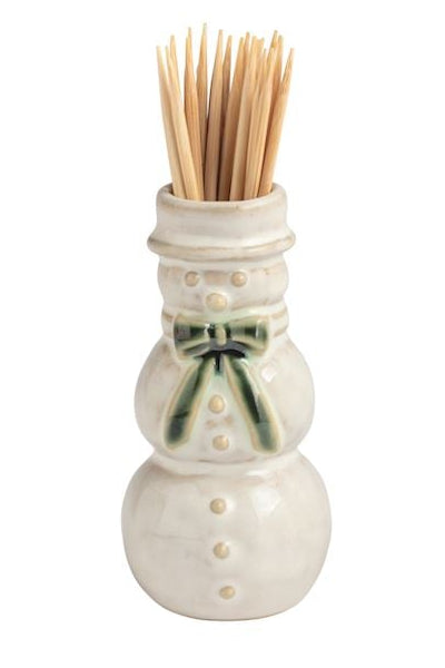 Four small ceramic toothpick holders shaped like a house with a green wreath, a snowman, a Santa figure, and a Christmas tree, arranged in a row on a white background.