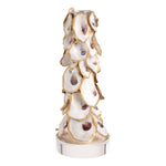 A decorative candle holder sculpted from stacked oyster shells with gold trim and a silver-toned base, shown on a plain white background.