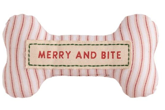 Set of six bone-shaped Christmas-themed dog toys with various sayings on a white background.