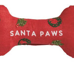 Set of six bone-shaped Christmas-themed dog toys with various sayings on a white background.