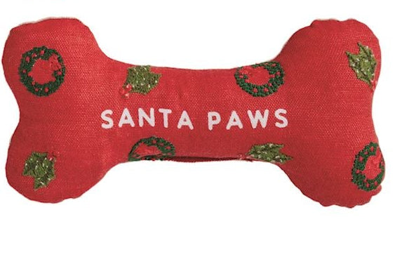 Set of six bone-shaped Christmas-themed dog toys with various sayings on a white background.