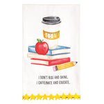 A white kitchen towel featuring a school-themed illustration with a coffee cup, books, an apple, and a pencil, plus the text 'I DON'T RISE AND SHINE. I CAFFEINATE AND EDUCATE.