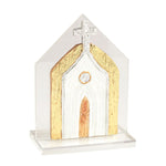 A small decorative church-shaped ornament or plaque with a clear acrylic outer frame and base, featuring a white arched center, textured gold side panels, a metallic gold door, and a silver cross on top, shown on a white background.