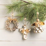 Decorative Christmas ornaments on a branch with pine needles on a light wooden background