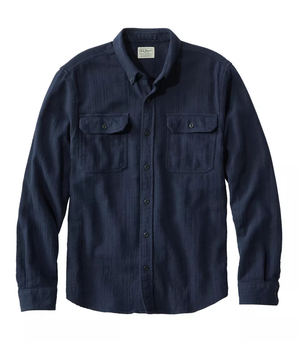 A dark navy blue long-sleeve button-up shirt with two buttoned chest pockets, displayed flat against a plain white background.