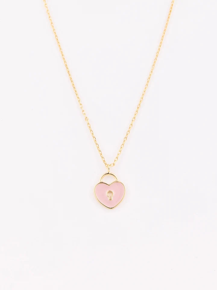 A delicate gold chain necklace featuring a small, open heart-shaped padlock pendant filled with light pink enamel and a tiny gold keyhole in the center, set against a plain white background.