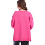 Person wearing a pink sweatshirt on a white background