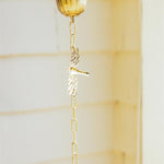 Eight-foot golden iron rain chain featuring decorative dragonflies, designed to guide rainwater while adding an elegant accent to porches and gardens.