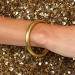 BuDhaGirl Aura Tzubbie All Weather Bangle with a wide metallic finish, styled alone or stacked for an elegant everyday look.
