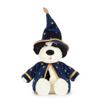 A plush dog toy dressed as a wizard, wearing a navy blue pointed hat and matching robe with gold star patterns and trim, on a plain white background.