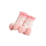 Pair of pink baby socks with white pattern on a white background