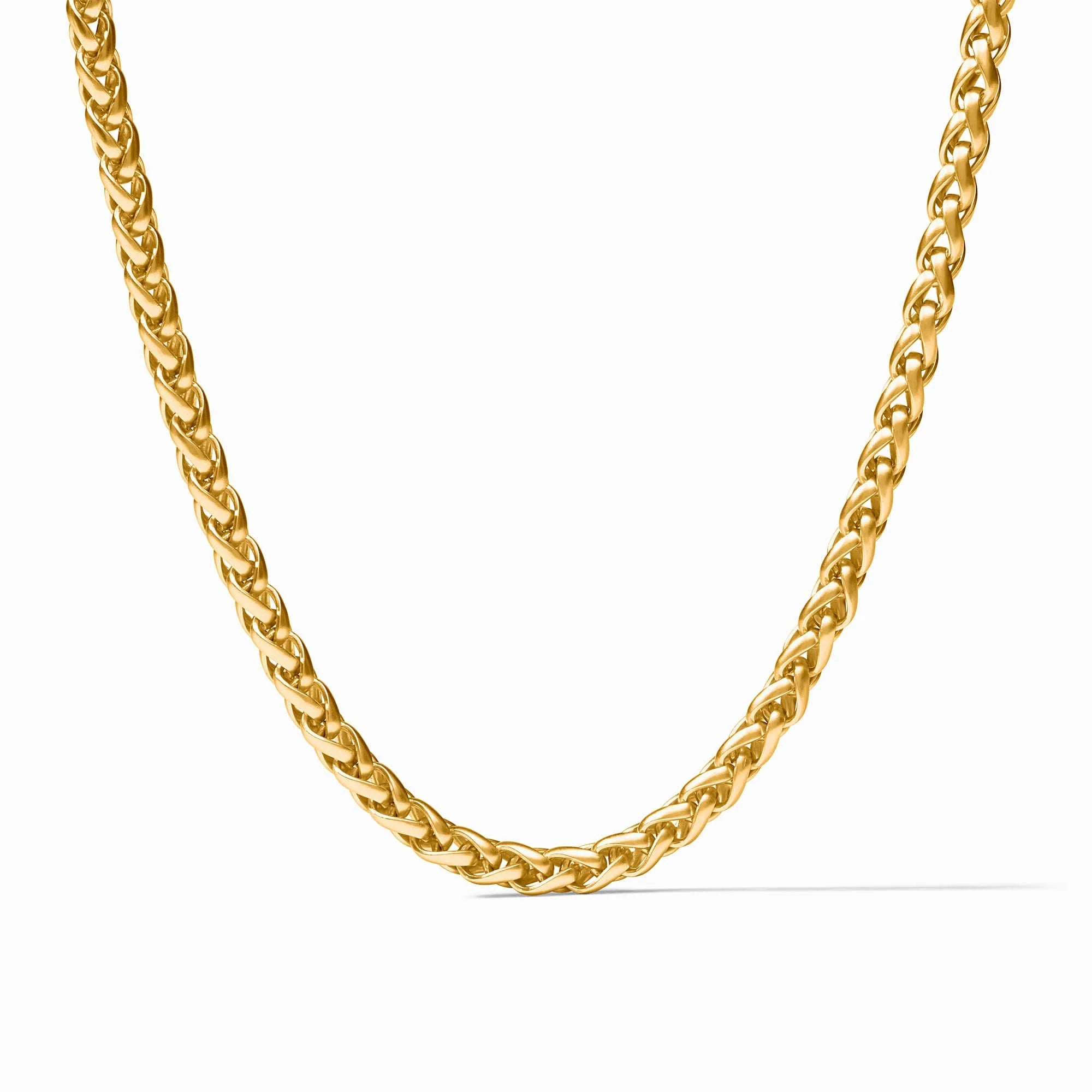 A close-up of a gold Cuban link chain necklace on a plain white background.