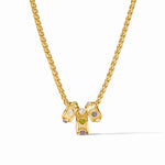 A gold chain necklace with a central pendant featuring three small cylindrical gold charms set with white, green, and lavender gemstones, shown on a clean white background.