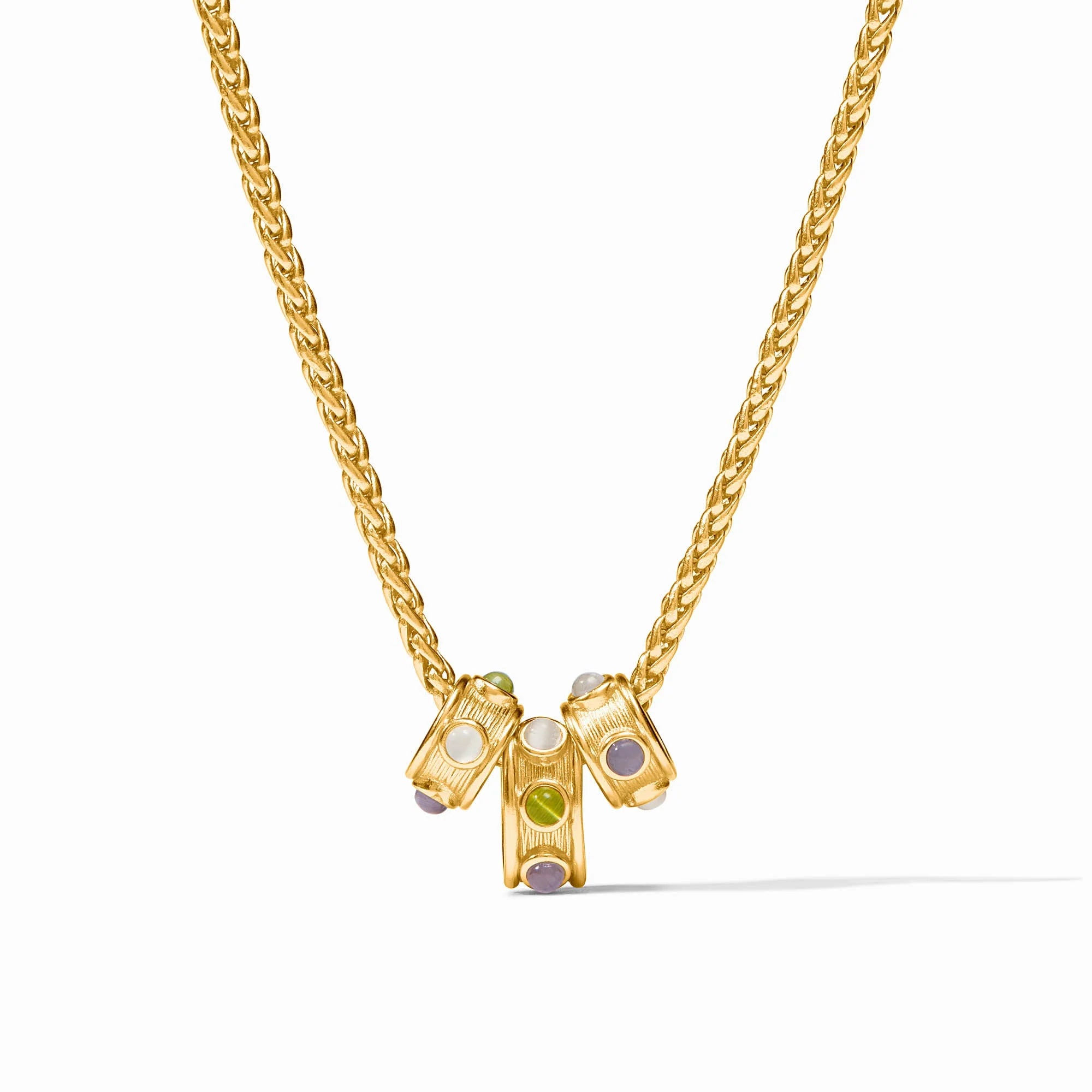 A gold chain necklace with a central pendant featuring three small cylindrical gold charms set with white, green, and lavender gemstones, shown on a clean white background.