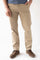 A man wearing beige slim-fit chino pants, a blue t-shirt, and brown leather lace-up shoes, standing against a white studio background.