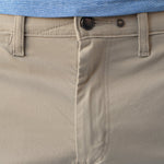 Close-up of beige pants with a blue shirt underneath