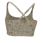 A women's sports bra with a beige, brown, and green camouflage pattern, featuring adjustable crossover back straps with silver buckles, shown against a plain white background.