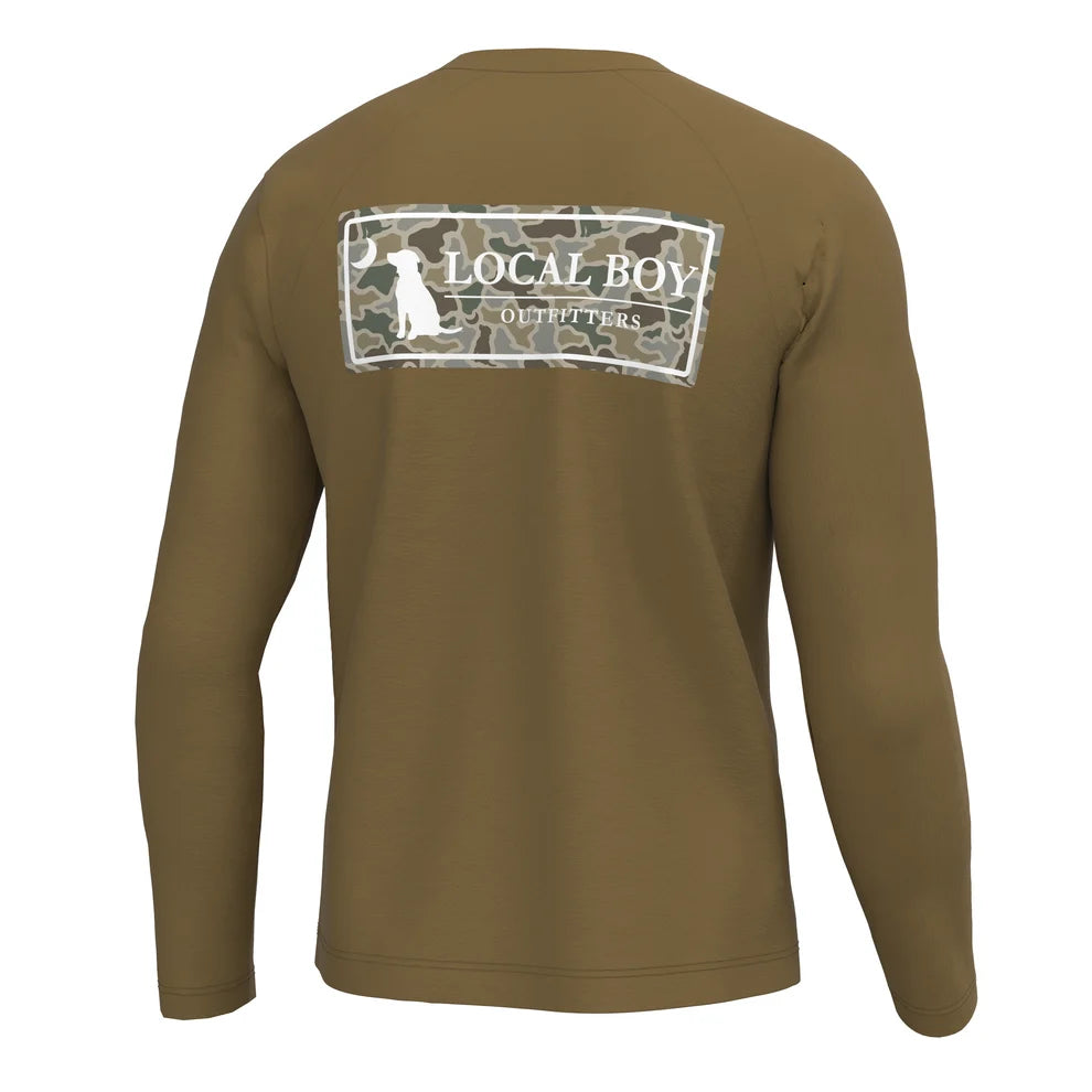 A brown long-sleeve shirt shown from the back, featuring a white graphic print on the upper back with a dog silhouette and the text 'LOCAL BOY' and 'THE PETTERS'.