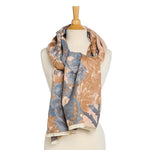 Floral patterned scarf on a mannequin against a white background
