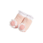 Pair of baby socks with floral design on a white background
