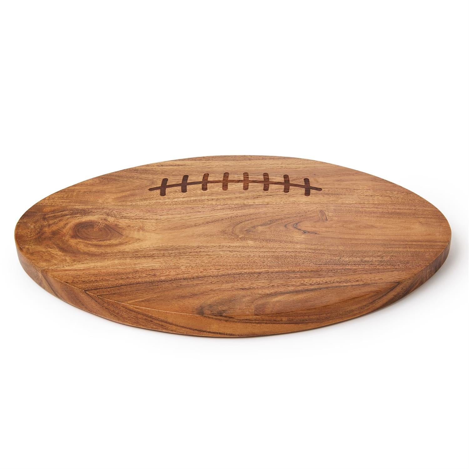 An oval wooden serving board shaped like a football, featuring a dark brown engraved lacing detail on the top surface, shown on a clean white background.