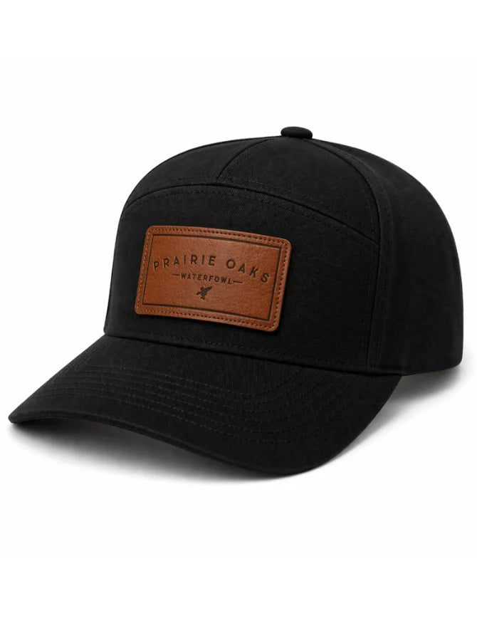 Prairie Oaks Waterfowl 7 Panel Hat in black featuring a contrasting brown Prairie Oaks logo patch and classic curved bill.