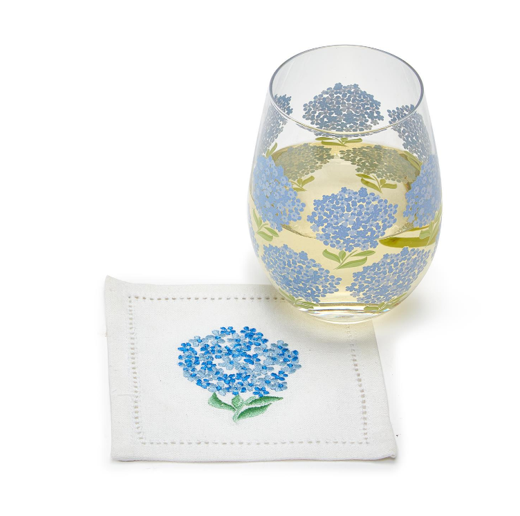 Stemless 16-ounce wine glass featuring blue hydrangea blooms and green leaves for a fresh, garden-inspired barware accent.