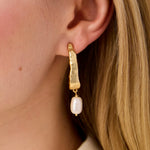 Spartina 449 Tumbled Hoop Earrings featuring hammered 24kt matte gold plating and freshwater pearl accents in a sculptural wave-inspired design.