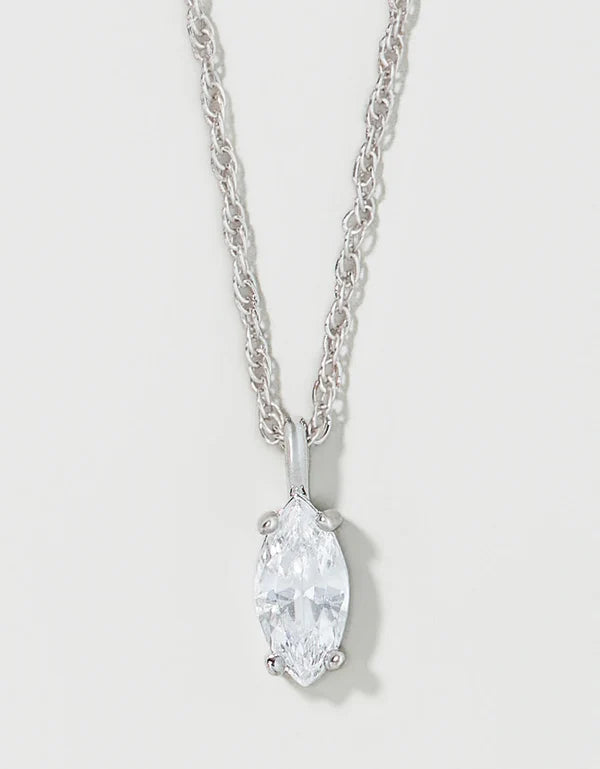 A silver-tone chain necklace with a marquise-cut clear gemstone pendant, shown against a light gray background.