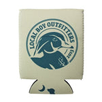 An off-white insulated can cooler sleeve featuring a dark teal circular duck graphic with the text 'LOCAL BOY OUTFITTERS 2013' and a small moon-and-dog print near the bottom, shown on a plain white background.