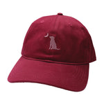 A dark red baseball cap featuring an embroidered silhouette of a sitting dog with a crescent moon on the front, set against a plain white background.