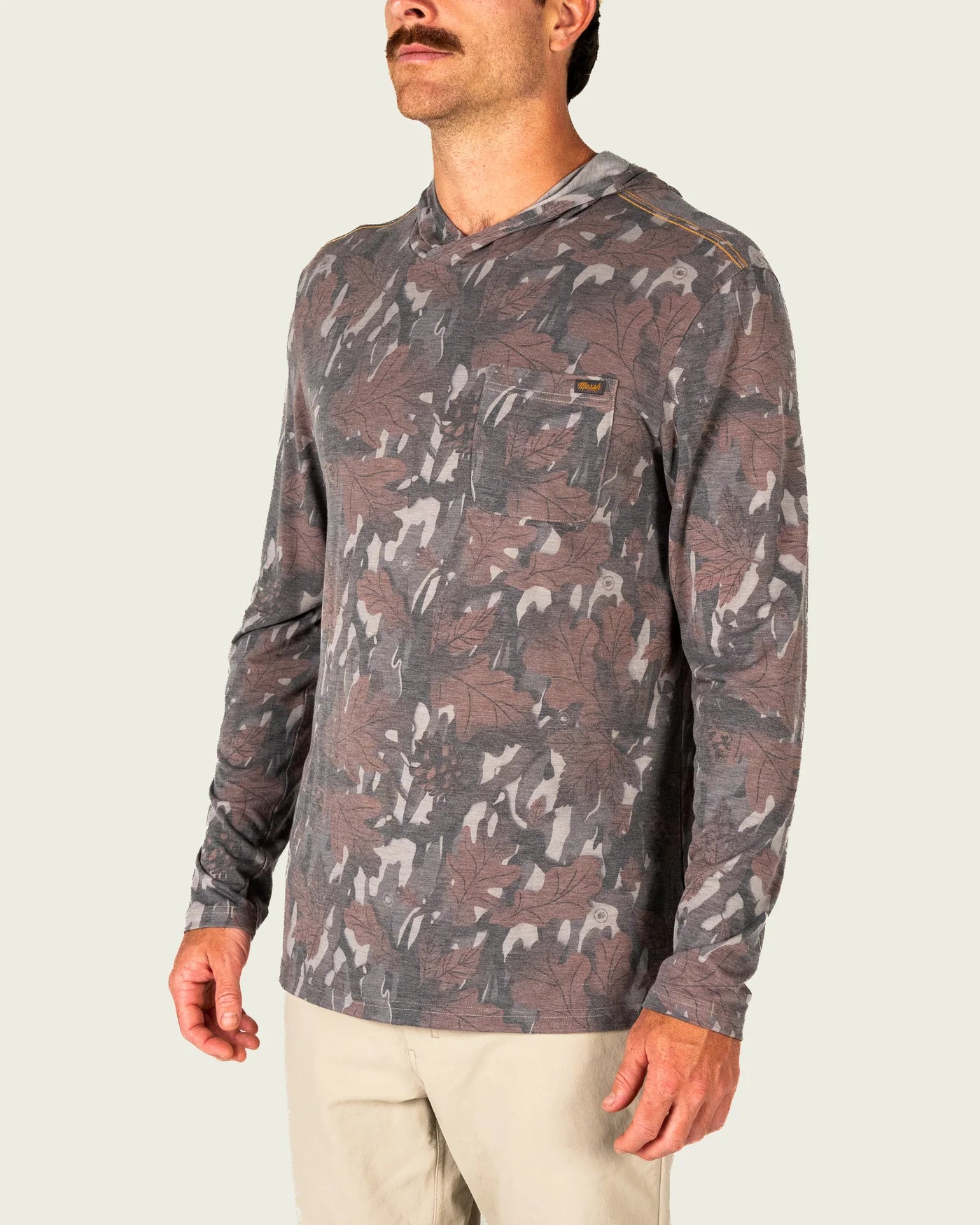 Marsh Wear Buxton Tech Hoodie in Lowland Canopy Camo featuring lightweight performance fabric, UPF 40 sun protection, hood, and thumb loops for fishing and outdoor wear.