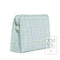 A light blue and green plaid zippered pouch with a white zipper pull, shown on a white background with a 'TRVL DESIGN' logo watermark in the bottom right corner.