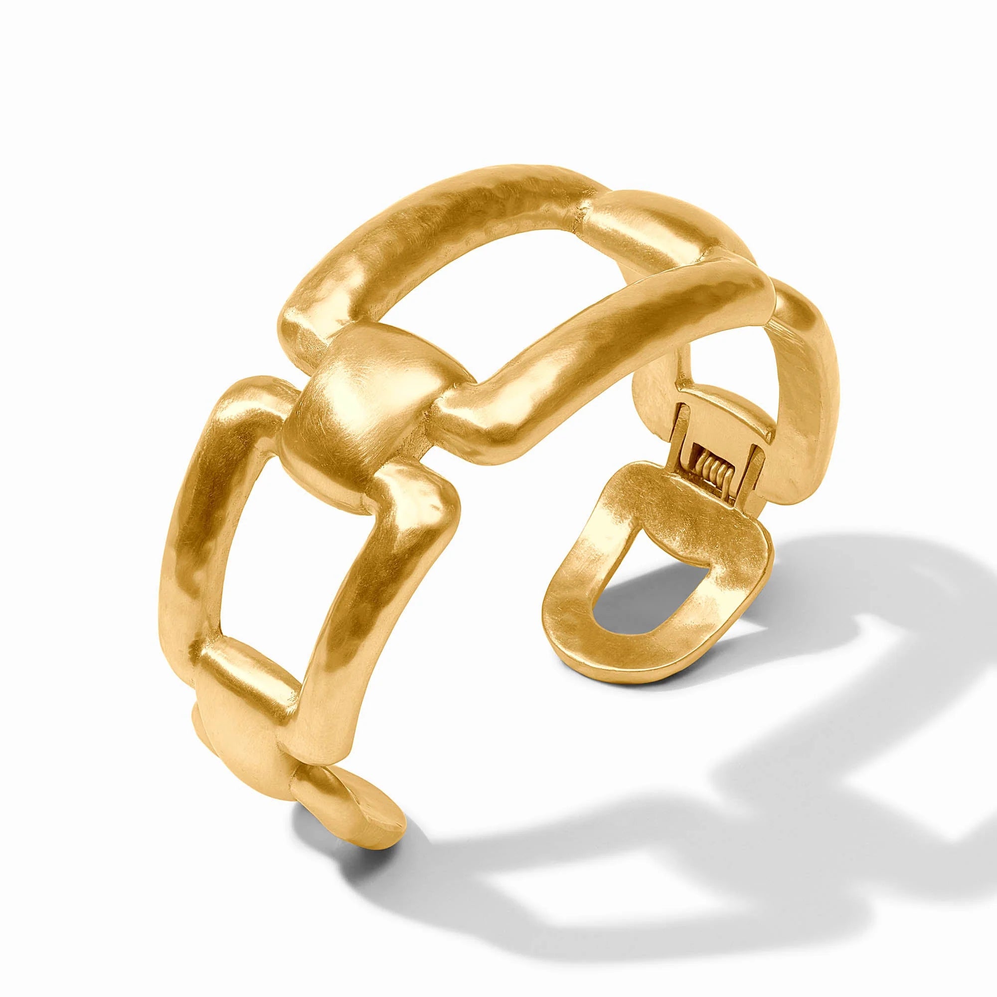 Gold cuff with a unique design on a white background