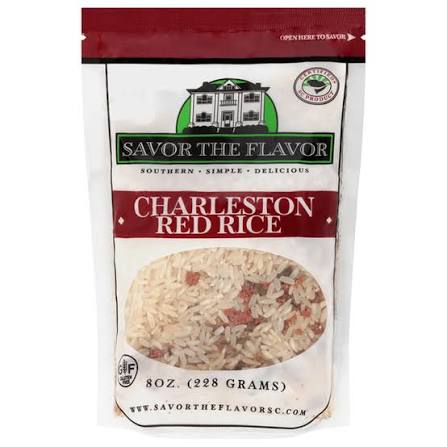 A 8 oz bag of Savor the Flavor Charleston Red Rice, featuring a white and red package design with a clear window showing the rice inside.
