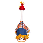 A small decorative goose figure wearing a red hat with yellow tassels, an orange, white, and black plaid shirt, and a blue apron with yellow fringe, displayed on a white mannequin against a light gray background.